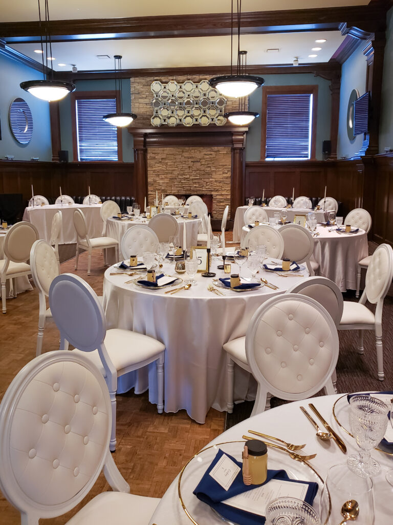 Photo of main event room decorated for a wedding in white colors.